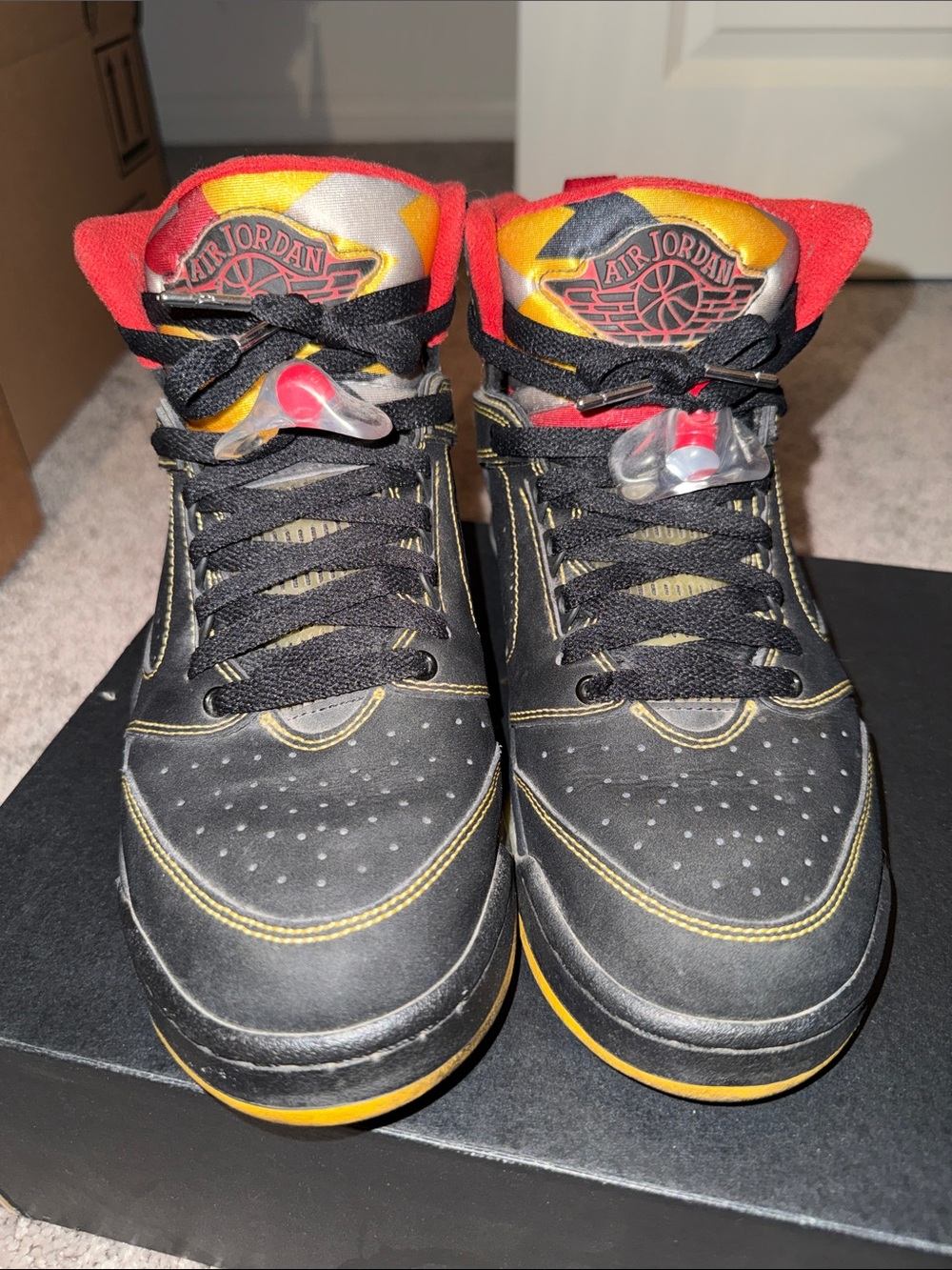 Jordan Black High-Top Sneakers with Red and Yellow Accents